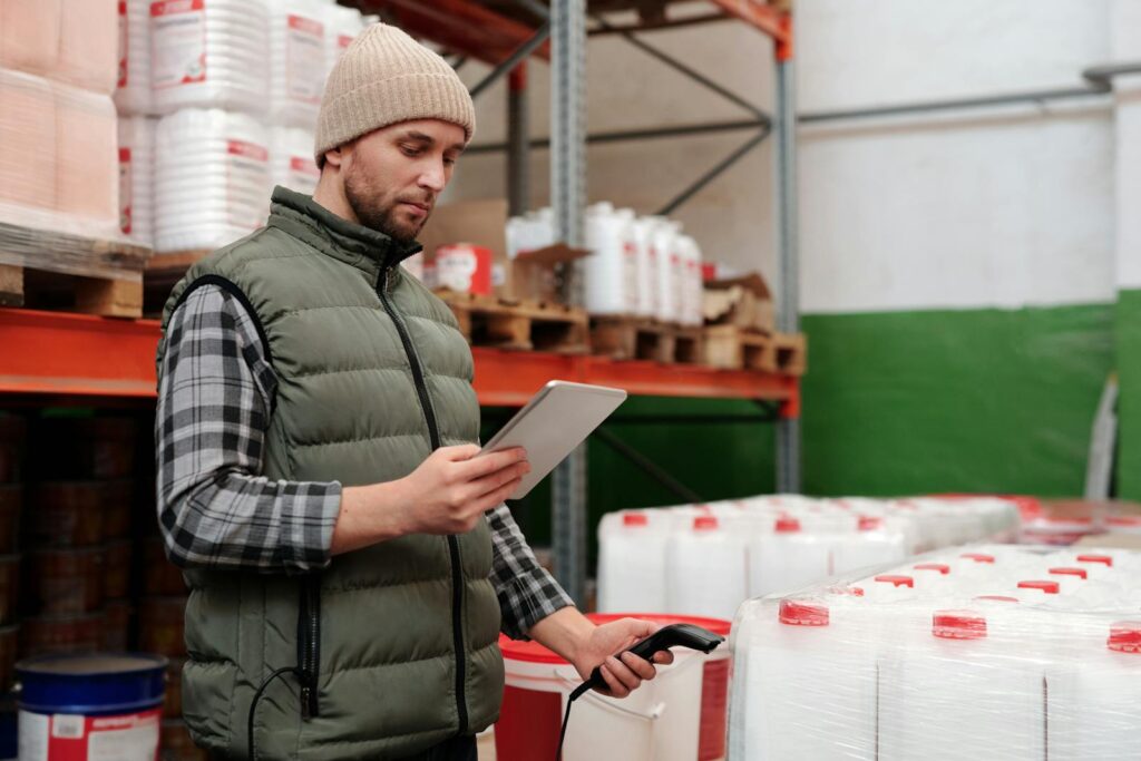 warehouse manager tracking inventory on tablet using FIFO method for efficient stock management